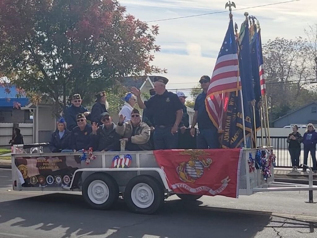 Veterans riding on float during Veterans' Day Parade