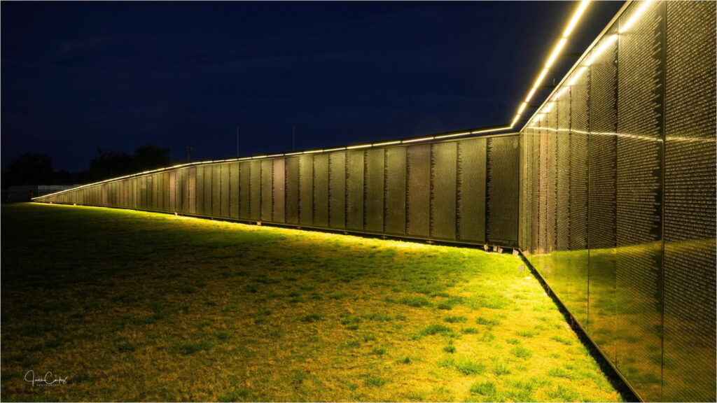 The wall that Heals lighted in orange for Agent Orange night. Photo by Juan Cortez
